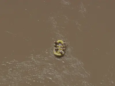 Aerial view of a yellow raft crossing a muddy rapid